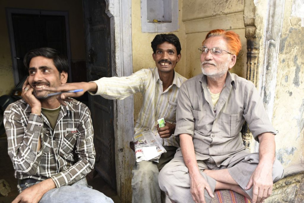 The man in the middle points to another man out of the frame that he wanted me to photograph. I took this man's picture instead, along with his amused buddies. The man on the right has coloured his hair with henna, which is quite common. (Richard McGuire photo)