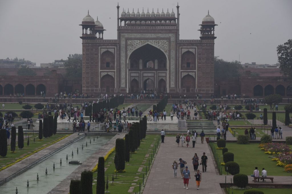 Tourists swarm around the entrance gate to the grounds of the Taj Mahal, many of them posing for photos. Then they make their way past the gardens to the Taj itself. (Richard McGuire photo)