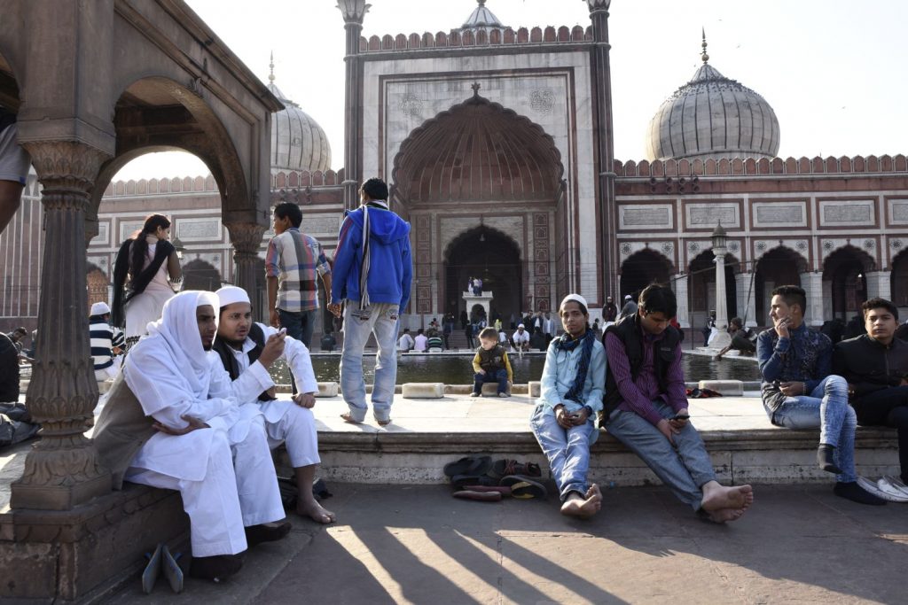 People hang out in front of the Jama Masjid prior to Friday evening prayers. Only men are allowed in the mosque itself. (Richard McGuire photo)