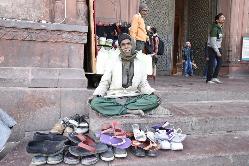This man watches shoes for a few rupees in front of the Jama Masjid, the major mosque in Old Delhi. People must remove their shoes to enter the mosque. (Richard McGuire photo)