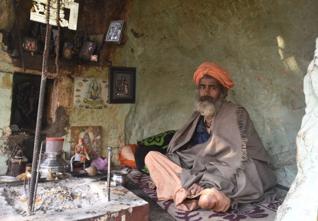This sadhu or holy man in Haridwar showed me his lair, built into a cave in a rock cut above the roadway. He had all his religious paraphernalia including a staff with the ancient swastika symbol on top. (Richard McGuire photo)