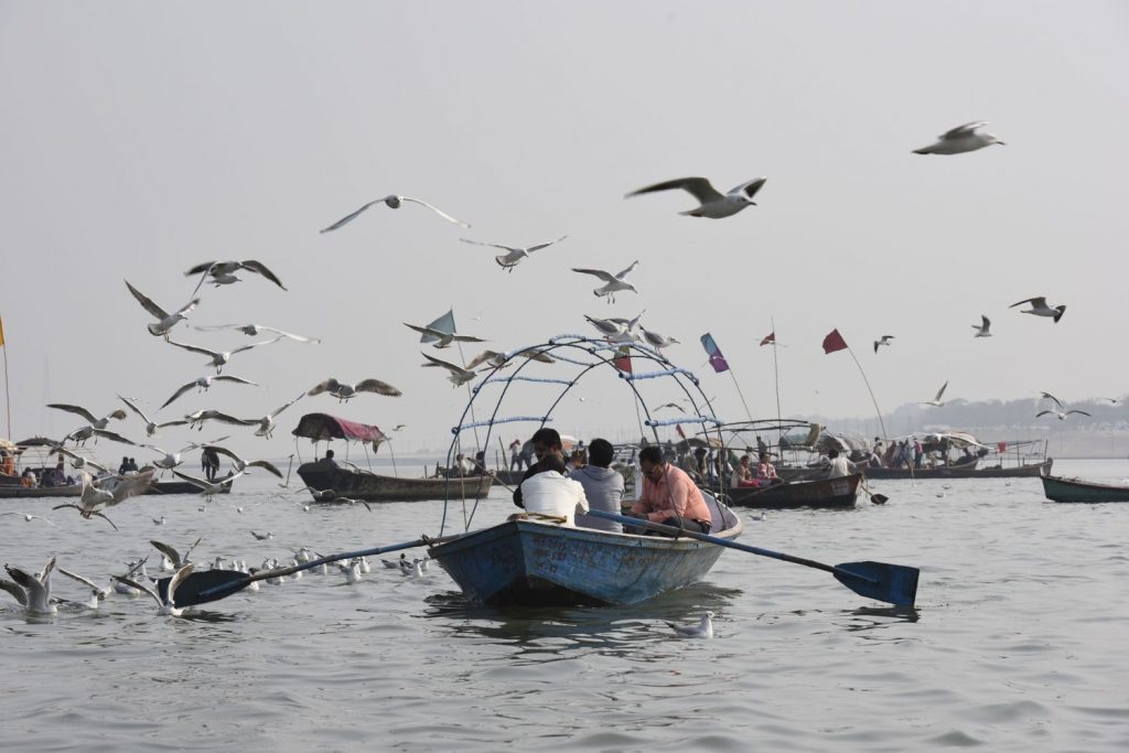 Devout Hindus hire boatmen to row them to Sangam, the confluence of the holy Ganges and Yamuna rivers to bathe. Often, especially when food has been offered, the boats are followed by hundreds of gulls. (Richard McGuire photo)