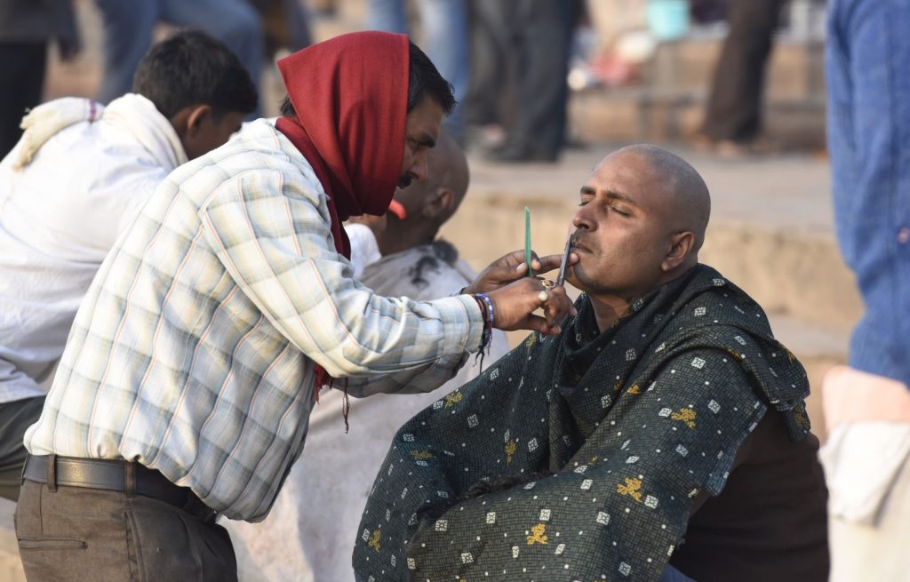 Many men get their heads and faces shaved by barbers on the ghats at Varanasi. (Richard McGuire photo)