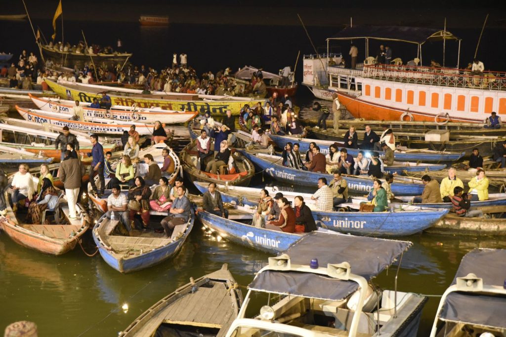 Many people, both Indians and tourists, get into boats to watch the ceremonies on the ghats by the Ganges as dusk falls on Varanasi. (Richard McGuire photo)