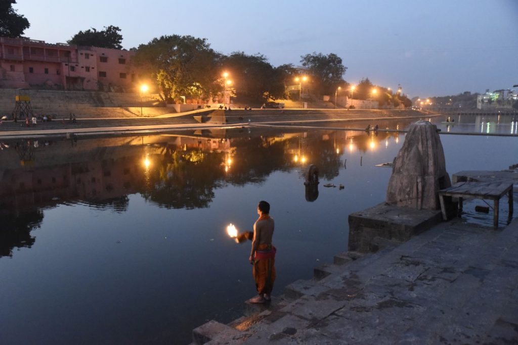 A priest holds a flaming torch by the river at Ram Ghat in Ujjain during the evening puja ceremony. (Richard McGuire photo) 