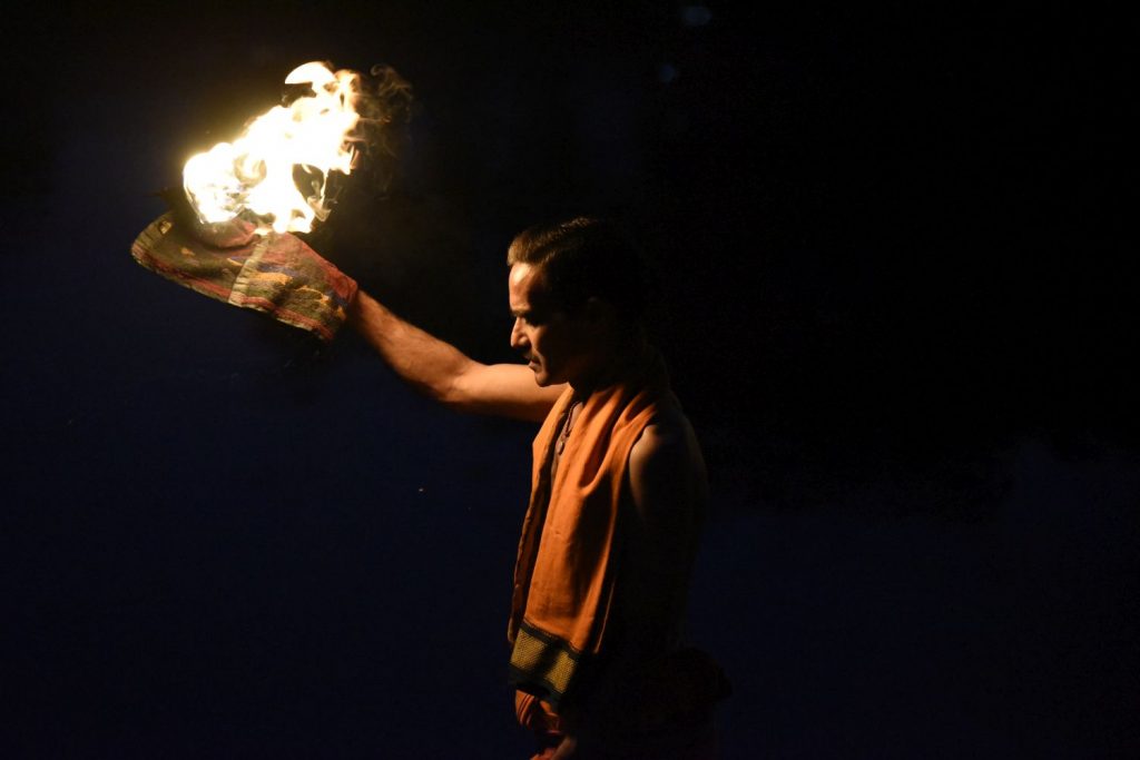 As dusk arrives, a priest holds up a flaming torch during puja ceremonies at Ram Ghat in Ujjain. (Richard McGuire photo)