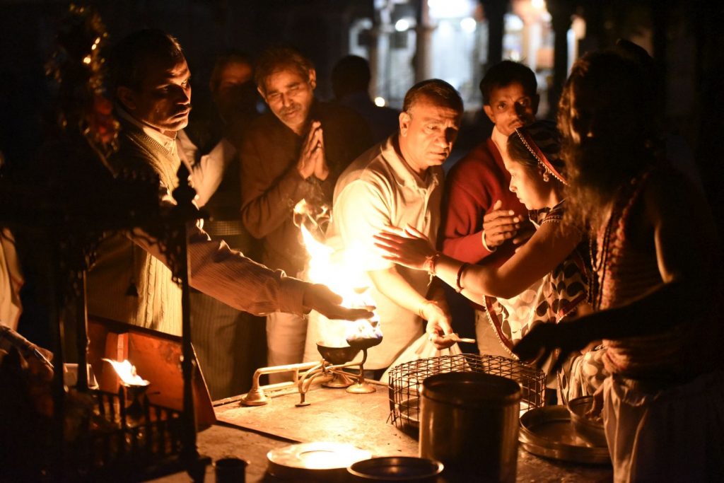 After the evening puja ceremony at Ram Ghat in Ujjain, devotes put their hands on the fire.(Richard McGuire photo)