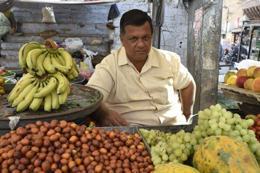 After I bought an orange from this fruit seller on a Jodhpur street, I asked if I could take his photo. He agreed, though he looked very dour even though he was friendly. I liked the way the colour of the tamarinds (?) matched his face while the bananas balanced the grapes and papayas. (Richard McGuire photo)