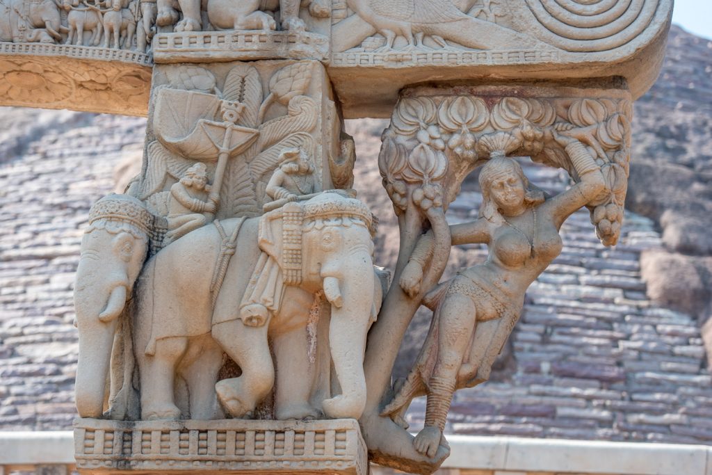 The Great Stupa at Sanchi was originally built for the emperor Ashoka the Great in the third century BC. Ashoka converted to Buddhism. This figure of a salabhanjika or stylized young woman is on the east gateway or torana. (© Richard McGuire photo)