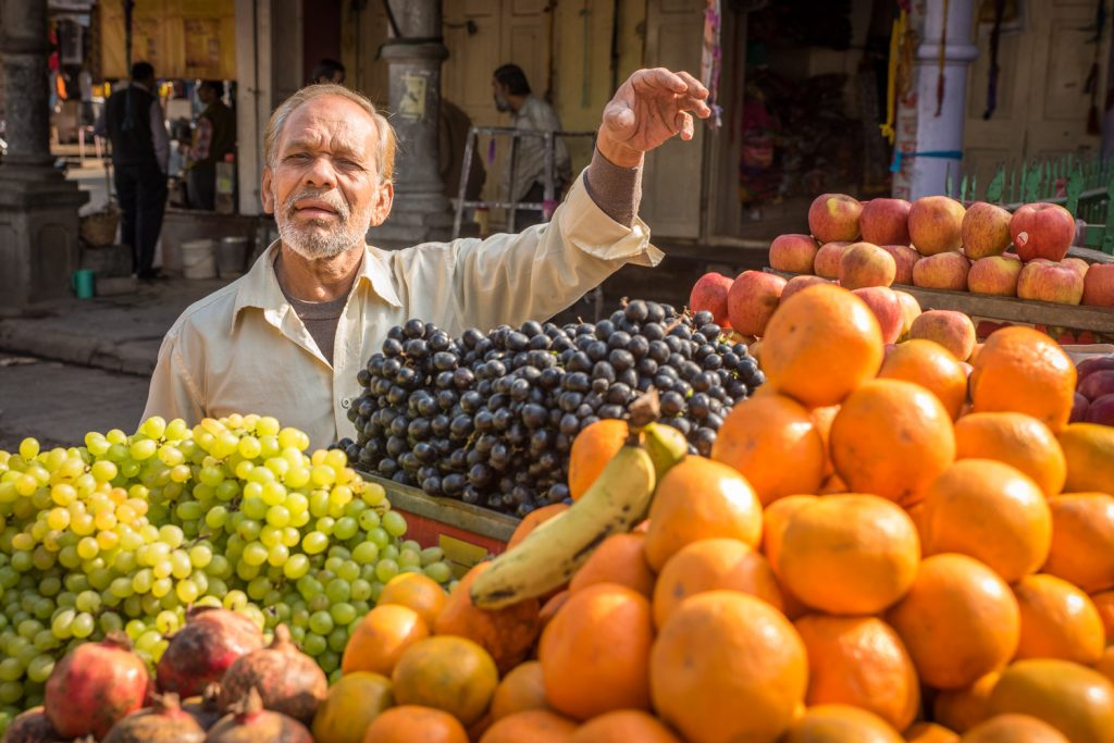 This fruit seller in Ujjain was selling grapes, pomegranates, oranges, bananas and apples. Ujjain is not touristy and people were friendly, often asking to pose when they saw my camera. (© Richard McGuire photo)