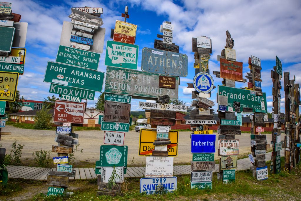 The Sign Post Forest at Watson Lake, Yukon has more than 100,000 place signs, distance signs, license plates and other signage left on posts by visitors from all over the world. It was started in 1942 by a homesick GI from Danville, IL, indicating 2,835 miles to his home town. Over the years it has grown so it it now is virtually a forest of signs. (Richard McGuire photo)