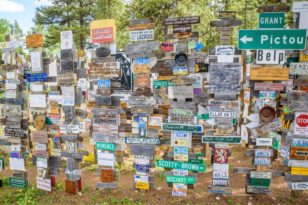 The Sign Post Forest at Watson Lake, Yukon has more than 100,000 place signs, distance signs, license plates and other signage left on posts by visitors from all over the world. It was started in 1942 by a homesick GI from Danville, IL, indicating 2,835 miles to his home town. Over the years it has grown so it it now is virtually a forest of signs. (Richard McGuire photo)