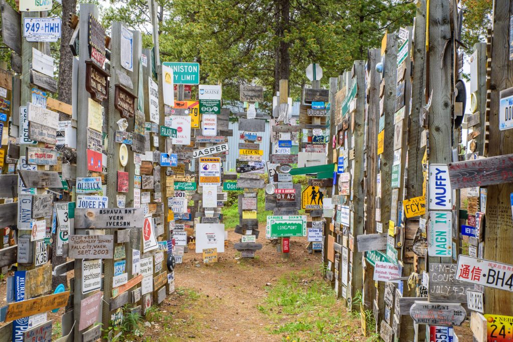 The Sign Post Forest at Watson Lake, Yukon has more than 100,000 place signs, distance signs, license plates and other signage left on posts by visitors from all over the world. It was started in 1942 by a homesick GI from Danville, IL, indicating 2,835 miles to his home town. Over the years it has grown so it it now is virtually a forest of signs. (Richard McGuire photo)