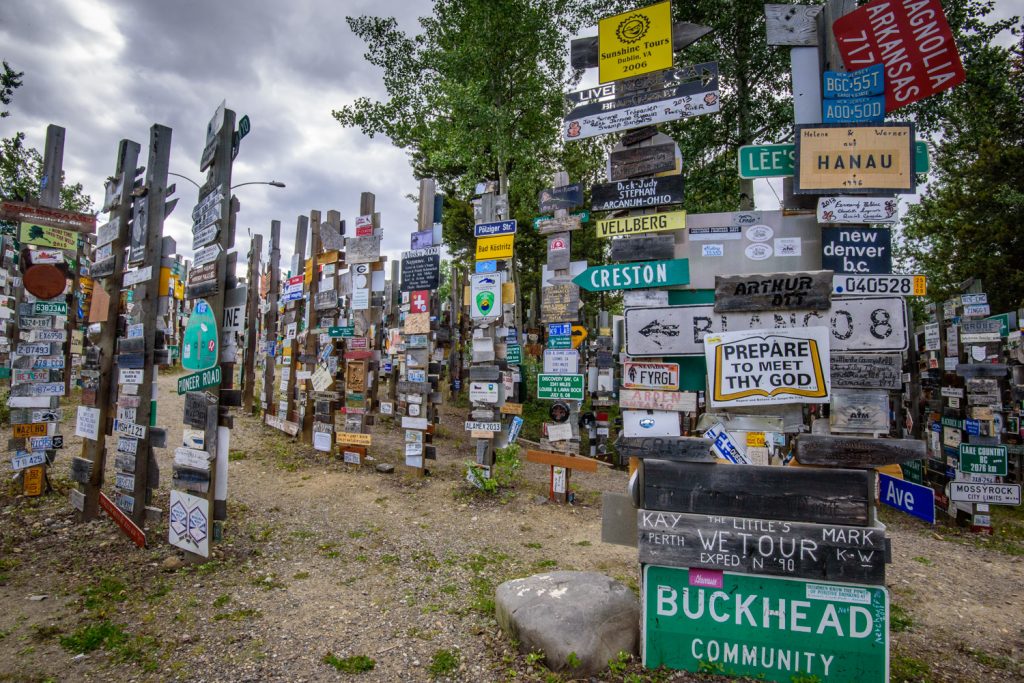 The Sign Post Forest at Watson Lake, Yukon has more than 100,000 place signs, distance signs, license plates and other signage left on posts by visitors from all over the world. It was started in 1942 by a homesick GI from Danville, IL, indicating 2,835 miles to his home town. Over the years it has grown so it it now is virtually a forest of signs. (Richard McGuire photo)