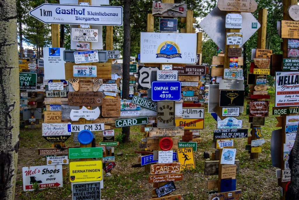 The Sign Post Forest at Watson Lake, Yukon has more than 100,000 place signs, distance signs, license plates and other signage left on posts by visitors from all over the world. It was started in 1942 by a homesick GI from Danville, IL, indicating 2,835 miles to his home town. Over the years it has grown so it it now is virtually a forest of signs. (Richard McGuire photo)
