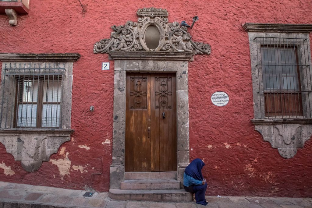A woman sits on the step of an old house in the historic centre of San Miguel de Allende. (Richard McGuire photo)