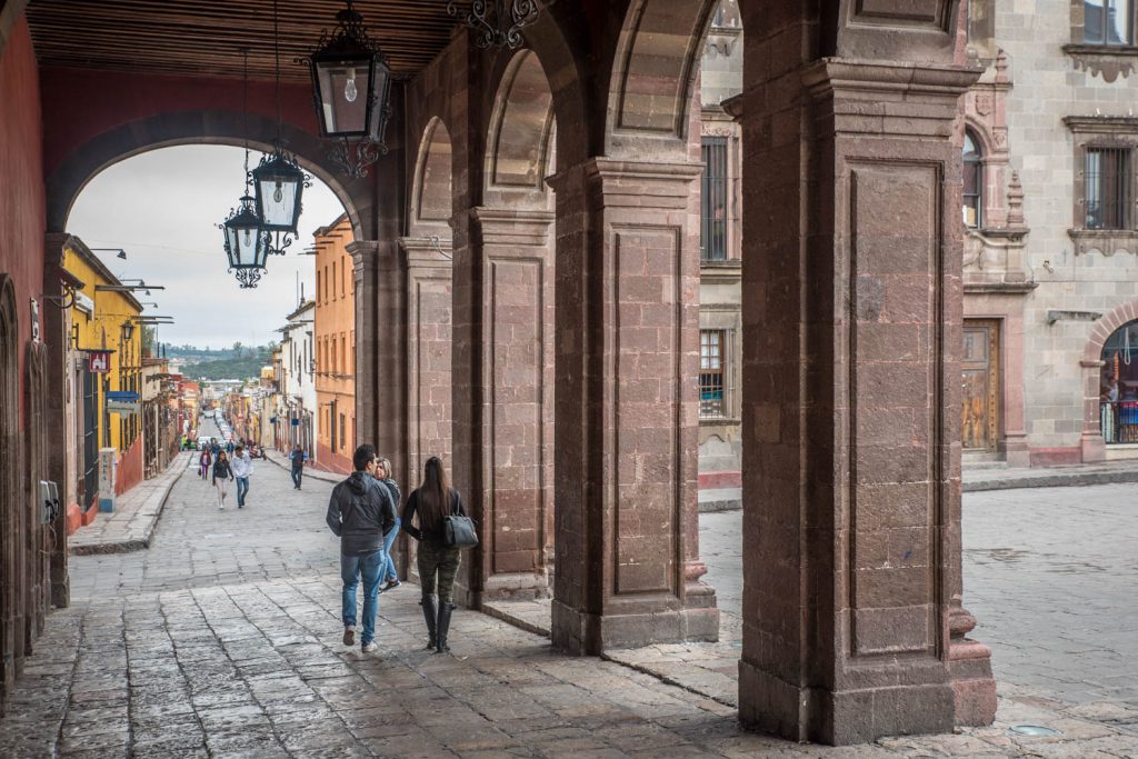 A couple walks under arches across from the main plaza in San Miguel de Allende. (Richard McGuire photo)