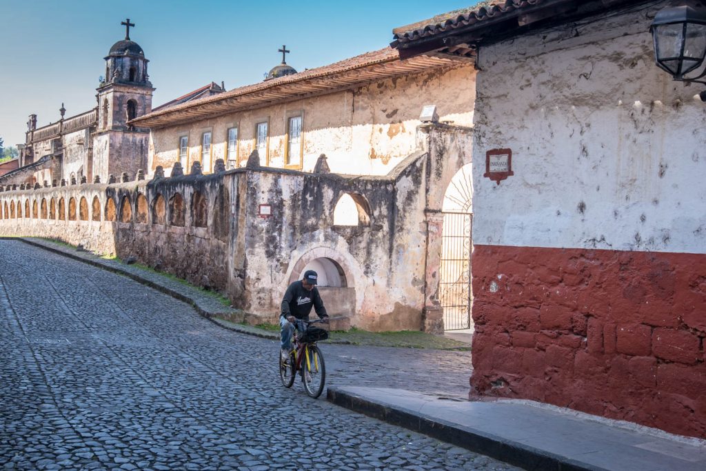 A man bicycles down a cobbled street, Calle Lerin, in Patzcuaro. (Richard McGuire Photo)