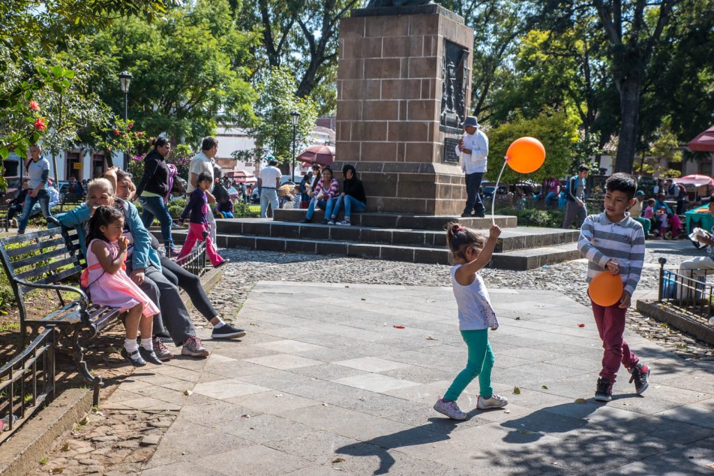 Children play and others relex in Patzcuaro's Plaza Chica, the informal name for Plaza Gertudis Bocanegra. (Richard McGuire Photo)