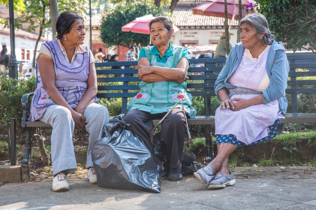 Three women chat on a bench in Plaza Chica in Patzcuaro. (Richard McGuire Photo)
