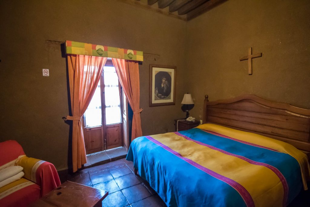 My room at Hotel Casa del Refugio, like others, has a religious theme. A small balcony looks out over the street. The walls are adobe and there's a high beamed cealing. (Richard McGuire photo)