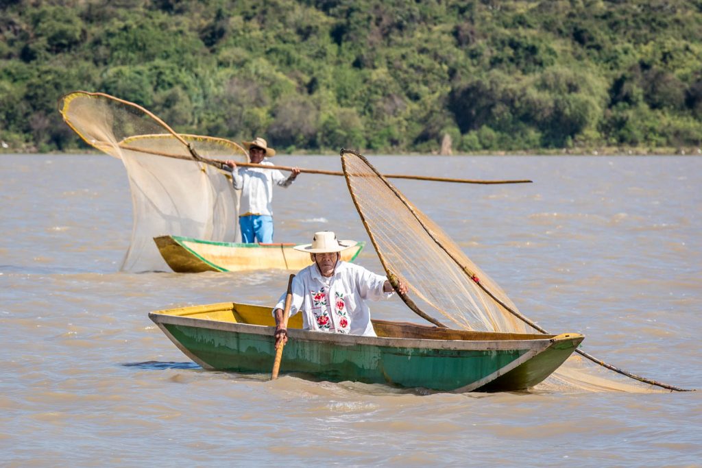 Fishing with butterfly nets like this is no longer economical, but the "fishermen" off Isla Janitzio fish for tips from tourist boats. (Richard McGuire photo)